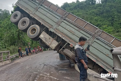 Xe tải lao xuống cầu, thùng xe chổng lên khiến đường lên cửa khẩu quốc tế bị tắc- Ảnh 1. Thùng xe tải vướng lại trên quốc lộ 15D khiến xe tải không thể lưu thông - Ảnh: HOÀNG TÁO