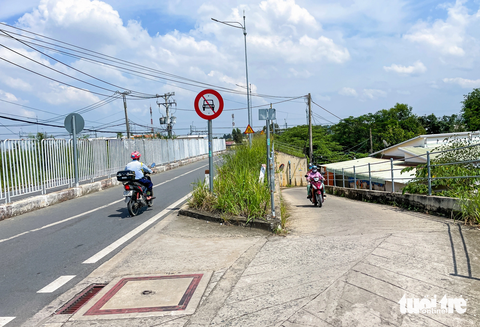 Khu dân cư bị bít lối, 300 người phải đi nhờ đường bến xe Miền Đông mới- Ảnh 5. Phía bến xe Miền Đông mới đổ bê tông một con dốc để dẫn xuống tổ 9 cho cư dân được đi nhờ con đường Hoàng Hữu Nam sau bến xe để ra xa lộ Hà Nội. Và hiện khoảng 300 nhân khẩu của tổ 9 không còn cách nào khác là đi nhờ con đường này - Ảnh: CHÂU TUẤN