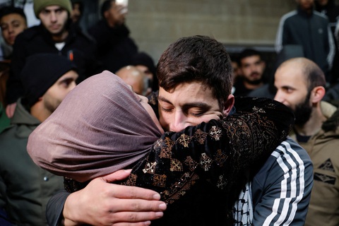 Israel và Hamas trao đổi con tin đợt 3- Ảnh 1. Một tù nhân Palestine được trả tự do tên Khalil Zamareh ôm lấy mẹ khi anh được gia đình đón ở Bờ Tây ngày 27-11 - Ảnh: REUTERS
