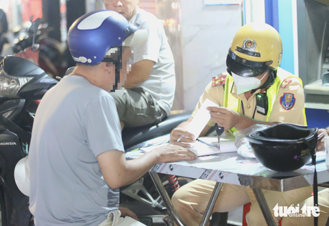 Lập chốt kiểm tra tại ngã tư Phú Nhuận, vẫn có người say lái xe không nổi, la hét ồn ào- Ảnh 1. Ông T. bị lập biên bản kịch khung vi phạm nồng độ cồn - Ảnh: MINH HÒA