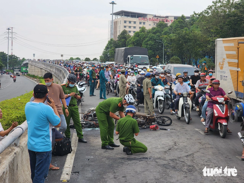 Hai xe máy bốc cháy sau va chạm trên cầu vượt Quang Trung, quận 12- Ảnh 4. Lực lượng chức năng tại hiện trường - Ảnh: NGỌC KHẢI