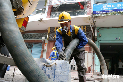 Những xô dầu mỡ được công nhân dùng máy hút để làm sạch Những xô dầu mỡ được công nhân dùng máy hút để làm sạch, xử lý nghẹt cống