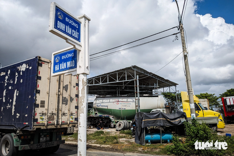 Gara, nhà xưởng mọc chui trên đất công, xã nói cho doanh nghiệp mượn - Ảnh 1. Một gara sửa chữa xe tải mọc lên trên khu đất công tại góc đường Đinh Văn Chất và Hà Văn Mao - Ảnh: TẤN LỰC
