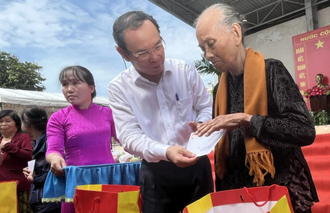 Bí thư Nguyễn Văn Nên : Phải tạo mọi điều kiện để dân được biết công việc của chính quyền - Ảnh 2. Bí thư Nguyễn Văn Nên tặng quà cho các hộ gia đình khó khăn - Ảnh: T.H.