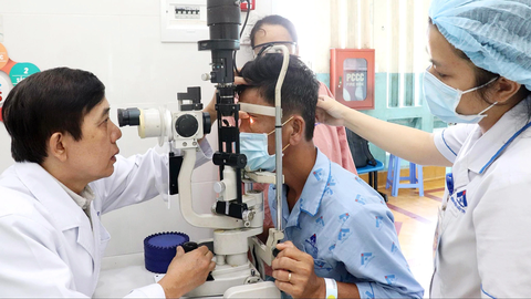 Mù mắt vì nghĩ cườm nước và cườm khô giống nhau- Ảnh 1. Bác sĩ Trang Thanh Nghiệp - trưởng khoa glaucoma Bệnh viện Mắt TP.HCM - thăm khám thị lực cho bệnh nhân bị mù mắt phải vì mắc bệnh cườm nước nhưng không điều trị kịp thời - Ảnh: XUÂN MAI