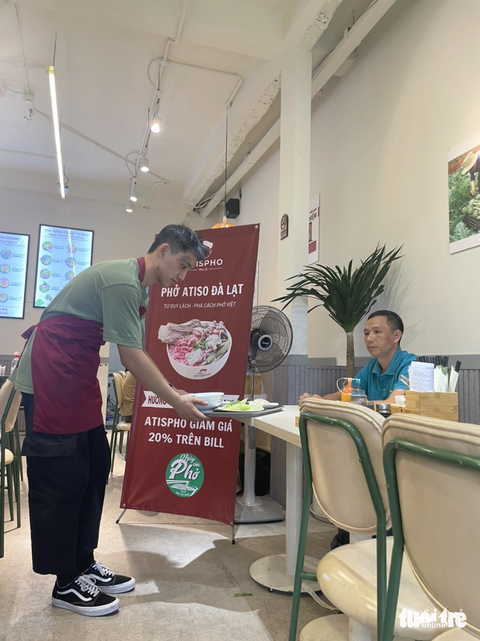 Anh Trang Mình Trường - chủ thương hiệu Atispho tự tay phục vụ khách trong Ngày của Phở 12/12. Ảnh: Đ.H Anh Trang Mình Trường - chủ thương hiệu Atispho - phục vụ khách trong Ngày của phở 12-12 - Ảnh: Đ.H