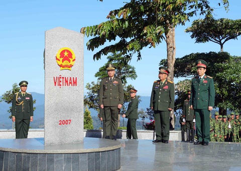 Giao lưu hữu nghị Quốc phòng biên giới Việt Nam - Lào - Campuchia lần thứ nhất- Ảnh 1. Ba bộ trưởng quốc phòng Việt Nam - Lào - Campuchia đã chào và tô son cột mốc chủ quyền - Ảnh: ĐÌNH CƯƠNG