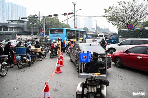 Người dân ùn ùn rời Hà Nội nghỉ Tết dương lịch, cửa ngõ kẹt cứng từ sáng đến trưa- Ảnh 3. Lượng xe tiếp tục tăng vọt khiến cảnh sát giao thông phải tạm cấm xe từ Hoàng Liệt đi thẳng qua ngã tư để vào vành đai 3. Tài xế được hướng dẫn rẽ phải sang Ngọc Hồi rồi vòng ngược lại ở điểm quay đầu