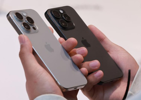 A customer holds two iPhones at an Apple Store in Myeong-dong, Seoul, Oct. 13. Yonhap Khách hàng xem điện thoại iPhone trong một cửa hàng ở Myeong-dong, Seoul, Hàn Quốc hôm 13-10-2023 - Ảnh: Yonhap