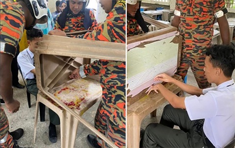 Nam sinh báo quá báo, mắc kẹt ngón tay vào mặt bàn học - Ảnh 1. Nam sinh báo quá báo, mắc kẹt ngón tay vào mặt bàn học - Ảnh 1.