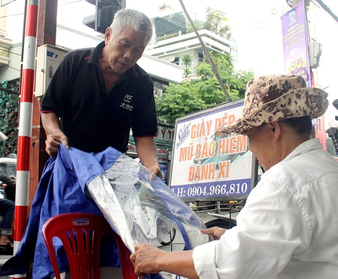 Khách đến vá áo mưa chủ yếu là người lớn tuổi, sinh viên - Ảnh: TRƯỜNG TRUNG Khách đến vá áo mưa chủ yếu là người lớn tuổi, sinh viên - Ảnh: TRƯỜNG TRUNG