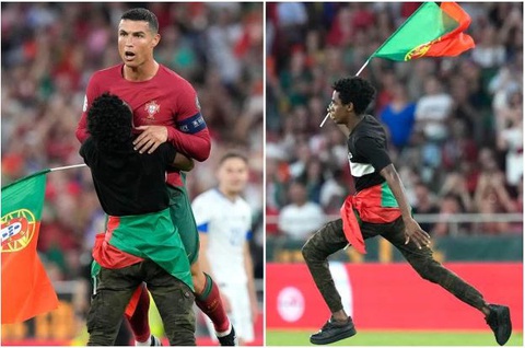 Ronaldo hết hồn vì bị cổ động viên chạy vào sân nhấc bổng - Ảnh 1. Ronaldo hết hồn vì bị cổ động viên chạy vào sân nhấc bổng - Ảnh 1.