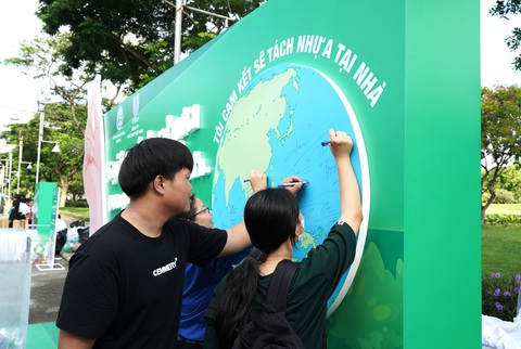 Người dân nói gì về việc phân loại rác tại nhà - Ảnh 3. Người tham dự hào hứng ký tên vào bức tường kỷ niệm như lời cam kết thực hiện tách nhựa tại nhà