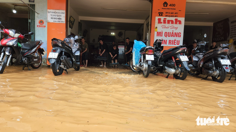 Đà Lạt mưa to, nhiều đoạn đường ngập nặng, dân vừa khóc vừa tát nước - Ảnh 6. Nhân viên quán ăn đẩy nước ra ngoài để kịp đón khách vào buổi chiều - Ảnh: M.V.