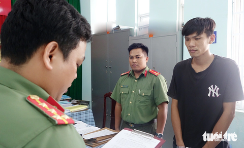 Bắt nghi phạm chế tạo, tàng trữ, mua bán trái phép súng, đạn - Ảnh 1. Phòng an ninh điều tra Công an tỉnh An Giang tống đạt các quyết định và lệnh bắt tạm giam bị can Lâm Thiện Nhật - Ảnh: TIẾN VĂN