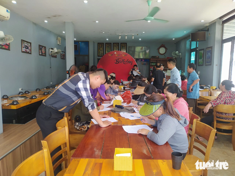 Khởi tố người đàn bà làm chủ đường dây hụi ở chợ Voi - Ảnh 2. Người dân kinh doanh ở chợ Voi viết đơn tố giác Thảo - Ảnh: LÊ MINH