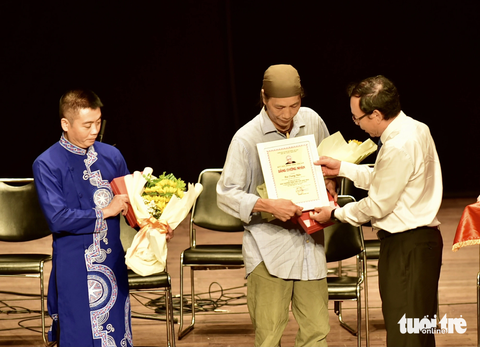 Chàng trai khiếm thị thổi sáo trúc nhận học bổng Trần Văn Khê năm 2023 - Ảnh 4. Bí thư Thành ủy TP.HCM Nguyễn Văn Nên trao giải thưởng cho nhà nghiên cứu Bùi Trọng Hiền, NSƯT Cồ Huy Hùng (trái) - Ảnh: T.T.D.