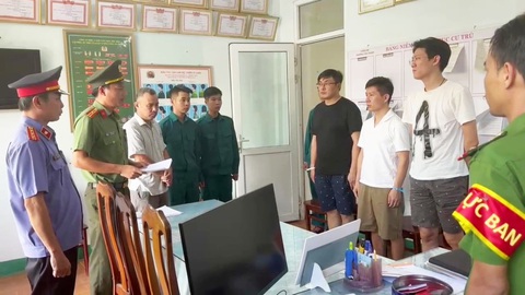 Thủ đoạn của đường dây cho vay nặng lãi 20.000 tỉ do người Trung Quốc cầm đầu thực hiện ra sao? - Ảnh 1. Đọc quyết định khởi tố bị can, lệnh bắt tạm giam đối với những người trong đường dây - Ảnh: PA05