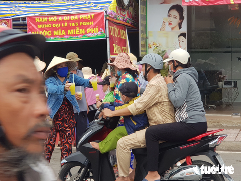 Chưa tới đại lễ 18-5, dòng người đổ về tấp nập, cơm nước miễn phí - Ảnh 2. Ven tuyến đường đổ về huyện Phú Tân có rất nhiều điểm cấp phát cơm, nước miễn phí cho khách hành hương