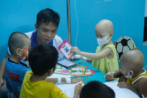 Lớp học vui vẻ của các bệnh nhi - Ảnh 1. Các em dù trên tay còn kim, còn truyền thuốc nhưng rất vui khi đến lớp học - Ảnh: NGỌC PHƯỢNG
