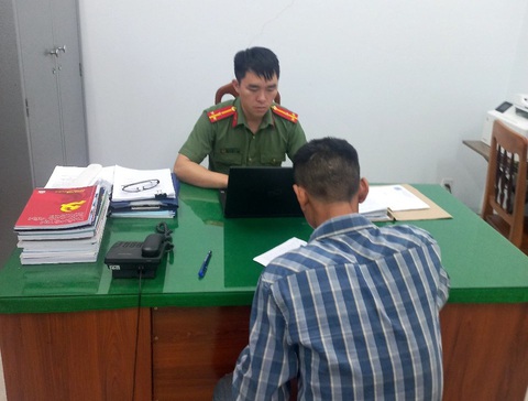 Phạt hai thanh niên đăng tin 'hàng chục chiếc đinh trồi ra từ tay người phụ nữ' - Ảnh 3. Cán bộ Phòng An ninh mạng và phòng, chống tội phạm sử dụng công nghệ cao làm việc với B.Đ.Đ. - Ảnh: TIẾN QUÂN