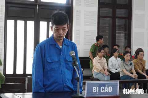 Xét xử lái xe chở rác bị cáo buộc cán nhiều lần khiến một cô gái chết - Ảnh 1. Bị cáo đứng trước tòa - Ảnh: Đ.C.