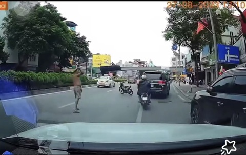Người đàn ông phi dao cắm vào kính ô tô Land Cruiser trên phố Hà Nội - Ảnh 1. Hình ảnh người đàn ông phi dao cắm vào kính ô tô Land Cruiser trên phố Hà Nội - Ảnh cắt từ clip