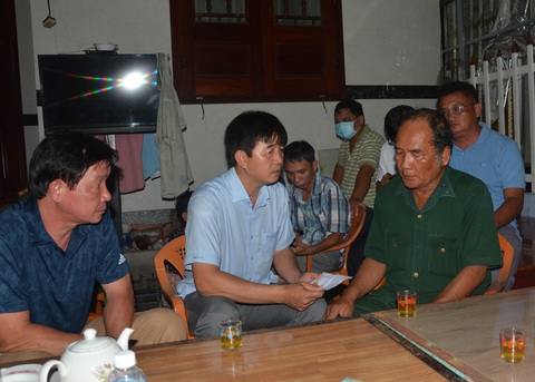Đề nghị công nhận liệt sĩ cho người đàn ông tử vong vì cứu người vụ cháy ở Phan Thiết - Ảnh 1. Chính quyền TP Phan Thiết, Bình Thuận thăm hỏi người nhà anh Nguyễn Hữu Đốn (áo xanh) trong đêm xảy ra cháy - Ảnh: ĐỨC TRONG