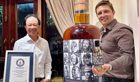 Chai whisky lớn nhất thế giới trị giá 1,4 triệu USD về tay nhà sưu tầm rượu từ Việt Nam - Ảnh 1. Ông Nguyễn Đình Tuấn Việt và ông Daniel Monk bên cạnh chai rượu whisky lớn nhất thế giới - Ảnh: PA