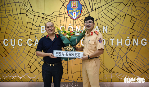 Chi hơn 4 tỉ đồng đấu giá biển ngũ quý 6, chủ xe nói đã phải xin phép 'nóc nhà' - Ảnh 1. Đại diện Cục Cảnh sát giao thông trao biển số trúng đấu giá cho khách hàng Nguyễn Thạc Đức - Ảnh: HỒNG QUANG