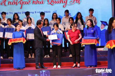 Tiếp sức đến trường: 20 mùa vượt khó cùng tân sinh viên Quảng Trị - Ảnh 17. Ông Lê Quốc Phong, nguyên chủ nhiệm CLB Nghĩa tình Quảng Trị, trao học bổng cho các tân sinh viên - Ảnh: HOÀNG TÁO