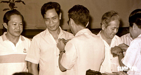Giáo sư Văn Tần trong góc nhìn của phóng viên Tuổi Trẻ: ‘Một đời thinh lặng cứu người’ - Ảnh 7. Khen thưởng các y bác sĩ tham gia ca phẫu thuật tách đôi cặp song sinh dính nhau Việt - Đức diễn ra tại Bệnh viện Từ Dũ ngày 4-10-1988. Bác sĩ Văn Tần (thứ hai từ trái qua) - Ảnh: NGUYỄN CÔNG THÀNH