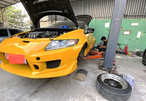 Thợ sửa xe tại một ga ra xe (huyện Nhà Bè, TP.HCM) tháo bánh xe ô tô độ chế thay bánh khác để đăng kiểm - Ảnh: TỰ TRUNG Thợ sửa xe tại một ga ra xe (huyện Nhà Bè, TP.HCM) tháo bánh xe ô tô độ chế thay bánh khác để đăng kiểm - Ảnh: TỰ TRUNG