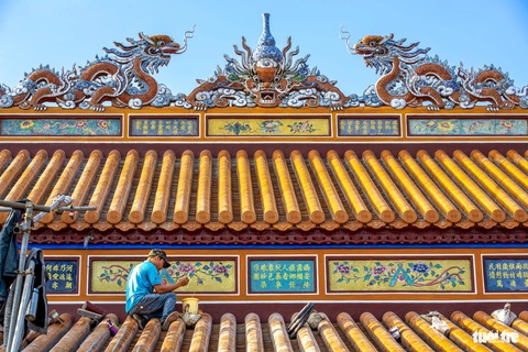 Trung tâm Bảo tồn di tích cố đô Huế: 42 năm hồi sinh di sản- Ảnh 2. Những người thợ thi công mái của điện Thái Hòa. Trước sự xuống cấp của ngôi điện quan trọng nhất bên trong Đại Nội Huế, Trung tâm Bảo tồn di tích cố đô Huế đã tiến hành công cuộc trùng tu điện Thái Hòa vào năm 2021 - Ảnh: NGUYỄN T.A. PHONG