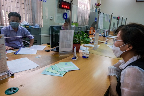 Tin tức sáng 24-1: Mua bán 'chui' cổ phiếu, vợ sếp bị phạt tiền tỉ; Xe qua ga Sài Gòn Tết ra sao?- Ảnh 2. Người dân làm thủ tục tại Bảo hiểm xã hội quận Hoàng Mai, Hà Nội - Ảnh: NAM TRẦN