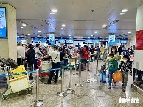 Tắc trên trời đến dưới đất, Tân Sơn Nhất đang gồng mình phục vụ- Ảnh 1. Người dân chờ tại nhà ga sân bay Tân Sơn Nhất - Ảnh: CHÂU TUẤN