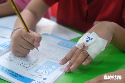 Lớp học vui vẻ trong bệnh viện- Ảnh 4. Dù trên tay vẫn còn ghim kim tiêm nhưng các em đều muốn đến lớp học để có thêm kiến thức - Ảnh: NGỌC PHƯỢNG