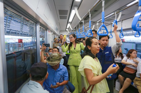 Người dân đi metro: ‘Hạnh phúc khi ngồi trên tàu, ngắm nhìn nhà mình’- Ảnh 5. Người dân thích thú dùng điện thoại ghi lại hình ảnh trên chuyến tàu metro - Ảnh: CHÂU TUẤN