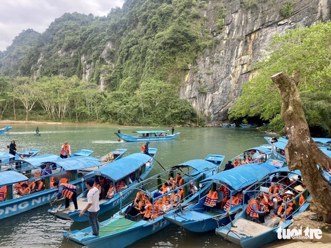 Vì sao nhiều người chọn đường Hồ Chí Minh để nườm nượp vào Nam?- Ảnh 2. Chiều mùng 4 Tết có rất đông du khách đến tham quan động Phong Nha. Trong đó có nhiều xe Bắc - Nam chọn ghé qua vì điểm tham quan này chỉ cách đường Hồ Chí Minh chừng 1km - Ảnh: TRƯỜNG TRUNG