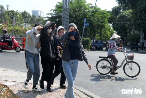 Thời tiết hôm nay 26-2: Nam Bộ sáng mát mẻ, trưa nắng nóng gay gắt- Ảnh 1. Các bạn trẻ đi bộ qua cầu Lê Văn Sỹ dưới cái nắng nóng trưa 24-2 - Ảnh: T.T.D.