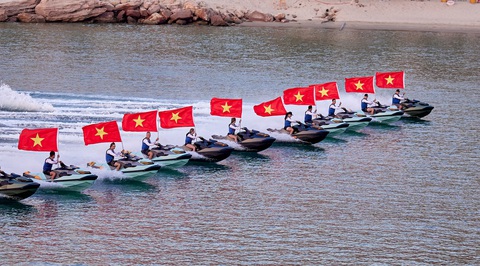 Du khách đã mắt với màn diễn Jetski và Flyboard ở Phú Quốc- Ảnh 3. Các vận động viên trình diễn Jetski kết hợp với lá cờ Tổ quốc tung bay trên vùng biển Phú Quốc - Ảnh: M.H.