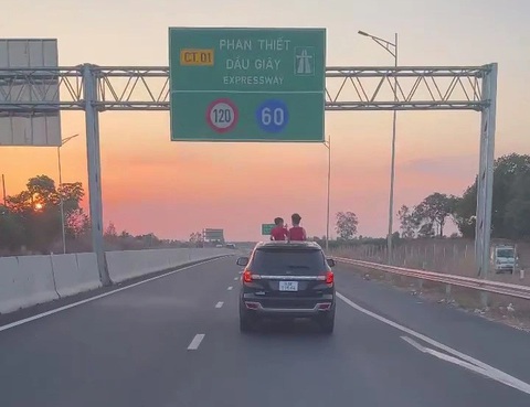 Để 2 cháu nhỏ vô tư 'hóng gió' trên cao tốc, cư dân mạng nổi nóng với phụ huynh- Ảnh 1. Hai cháu nhỏ thò đầu lên cửa sổ trời khi xe đang chạy trên cao tốc rất nguy hiểm - Ảnh: Cắt từ video