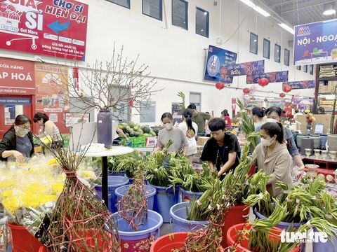 Chợ tăng giá, khách đến siêu thị mua sắm ngày 29 Tết đông nghẹt- Ảnh 1. Khách vào siêu thị mua hoa ngày 29 Tết do giá cả ở đây ổn định, không tăng mạnh như chợ truyền thống - Ảnh: N.BÌNH