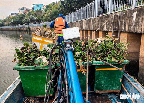 UBND TP.HCM chỉ đạo khẩn vụ thu gom rác trên kênh Nhiêu Lộc - Thị Nghè- Ảnh 3. Nhân viên gom rác mé kênh Nhiêu Lộc - Thị Nghè ngày 10-3 - Ảnh: CTV