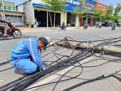 Xe tải đi vào đường cấm làm hàng loạt trụ điện gãy đổ- Ảnh 3. Nhân viên nhà mạng đang xử lý đường dây - Ảnh: TRẦN MAI