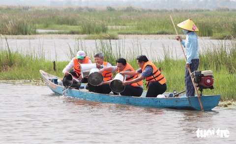 Bãi sậy sông Đầm - hệ sinh thái quý hiếm giữa lòng Tam Kỳ- Ảnh 18. Lãnh đạo Bộ Tài nguyên và Môi trường và tỉnh Quảng Nam thả cá giống ở sông Đầm, nhằm hưởng ứng Năm Phục hồi đa dạng sinh học quốc gia - Ảnh: LÊ TRUNG