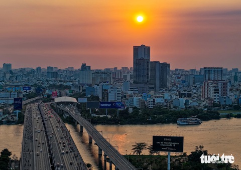 Ngắm hoàng hôn ở TP.HCM: Mặt trời như lòng đỏ trứng nhuộm cam cả một khoảng trời- Ảnh 2. Góc ngắm hoàng hôn từ chân cầu Sài Gòn hướng về quận Bình Thạnh. Ghi nhận chiều 25-3 - Ảnh: CHÂU TUẤN