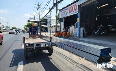 Ớn lạnh xe ba gác chở sắt thép, tôn dài ngoằng chạy trên đường TP.HCM- Ảnh 1. Xe ba gác chở hàng chục thanh sắt dài chạy trên quốc lộ 13, phường Hiệp Bình Phước, TP Thủ Đức sáng 30-3 - Ảnh: MINH HÒA
