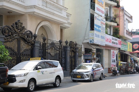Thiếu bãi, taxi đậu ngổn ngang tại trung tâm TP.HCM- Ảnh 5. Nhiều xe đậu trước cửa nhà người dân trên đường Đặng Văn Sâm (quận Tân Bình) gây khó khăn cho việc đi lại - Ảnh: THU DUNG