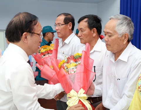 Chủ tịch TP.HCM Phan Văn Mãi dự lễ sắp xếp ấp tại xã An Thới Đông, Cần Giờ- Ảnh 2. Bí thư Huyện ủy huyện Cần Giờ Nguyễn Phước Hưng tặng hoa các cán bộ không chuyên trách được cử giữ chức vụ ở ấp mới - Ảnh: THẢO LÊ